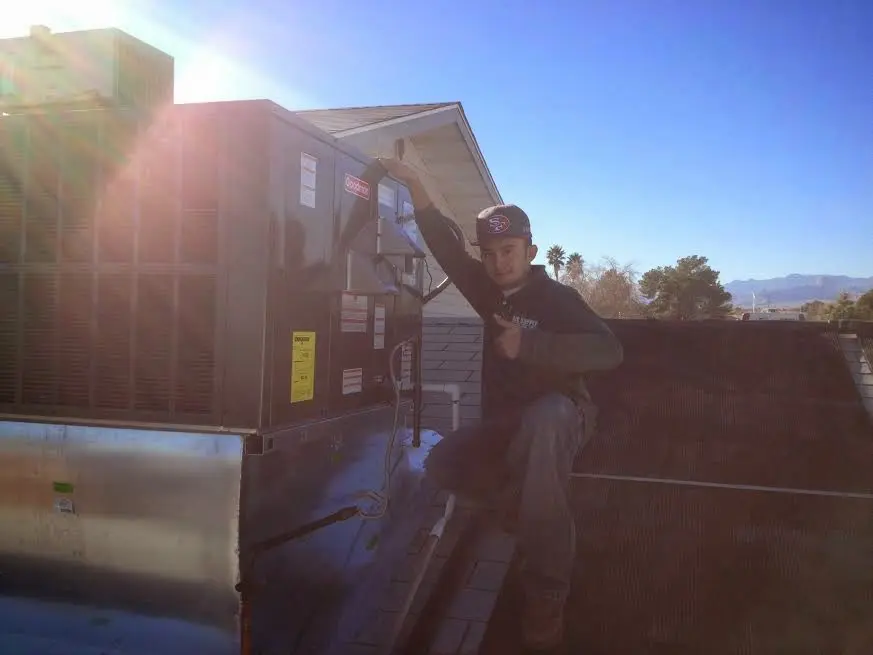 HVAC technician performing HVAC Inspection on a rooftop unit in Mineral Wells